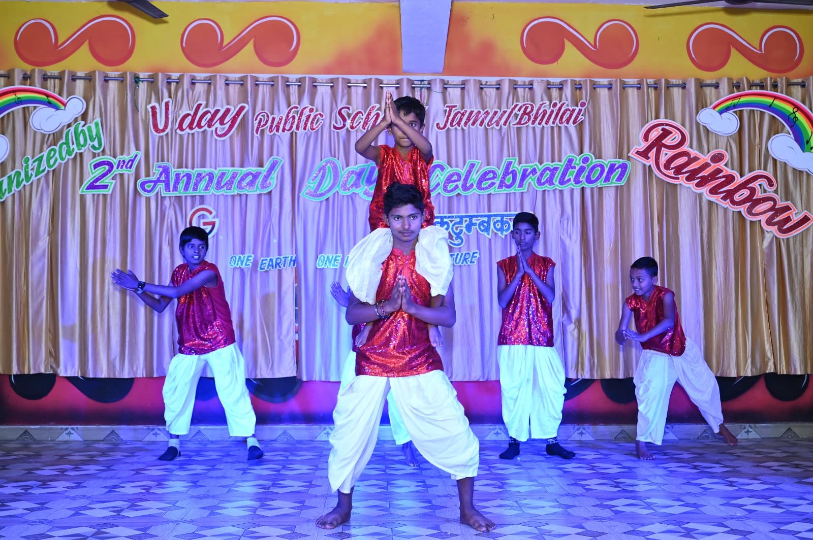 Students performing a group dance on stage